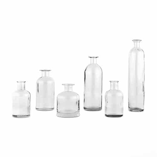 6 clear vases for wedding centerpiece on white background in varying sizes