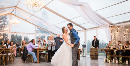 bride and groom dancing under clear tent at pine and pond